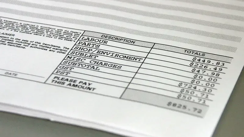 Close-up van een factuur met omschrijving en bedragen, met onderaan de regel 'please pay this amount'