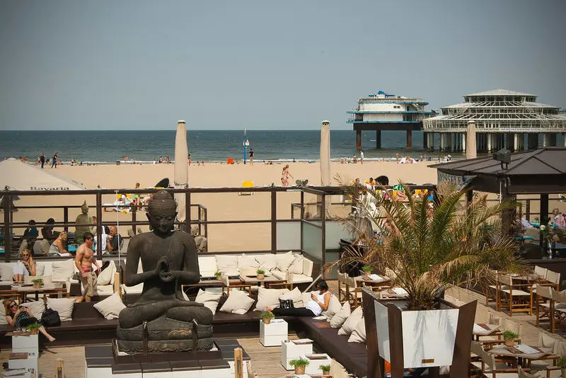 Zonnig strand van Scheveningen met pier en strandtenten